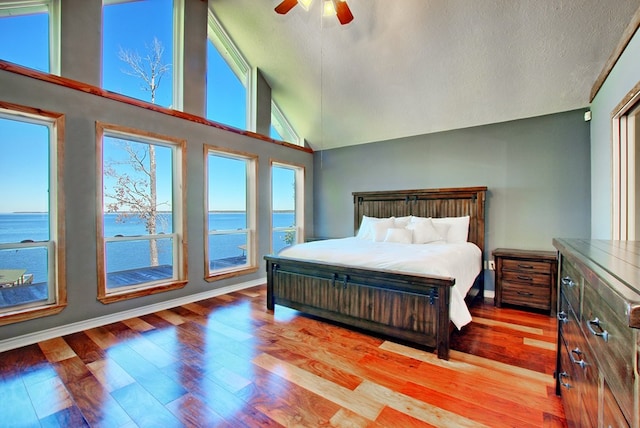 160 Somerset, Milam, TX 75959 - bedroom with multiple windows, ceiling fan, a water view, and light hardwood / wood-style floors