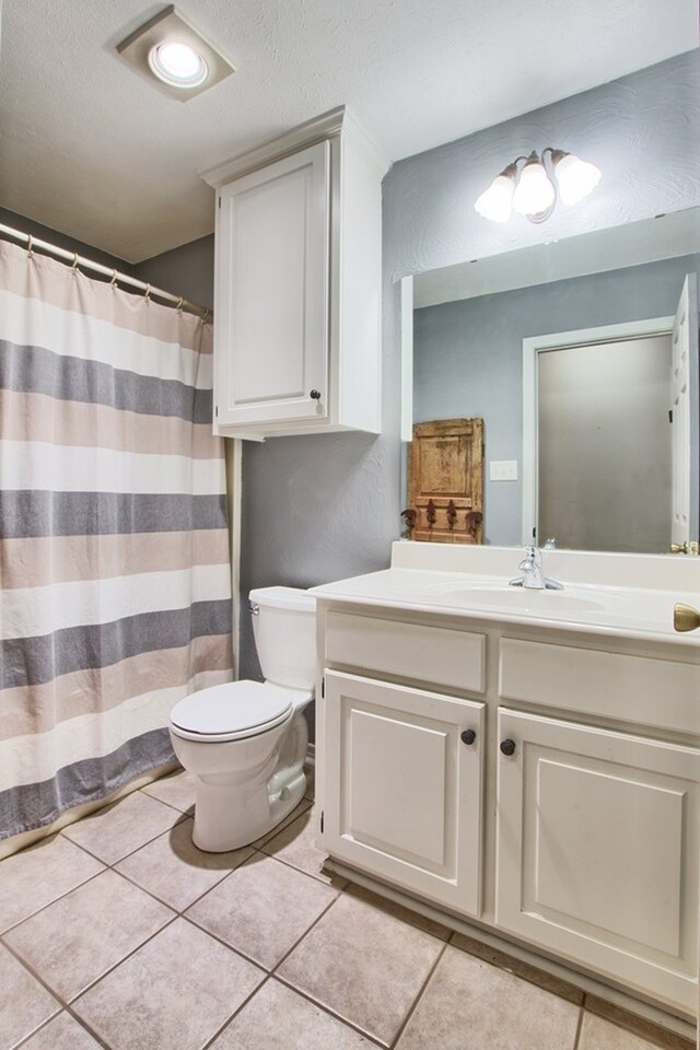 160 Somerset, Milam, TX 75959 - bathroom featuring tile patterned floors, vanity, and toilet