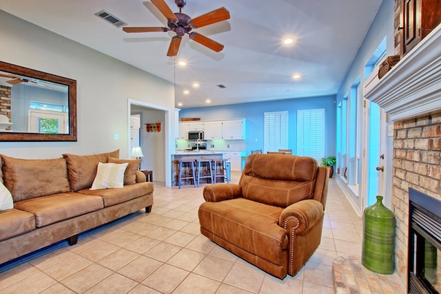 160 Somerset, Milam, TX 75959 - living room featuring a brick fireplace and light tile patterned flooring