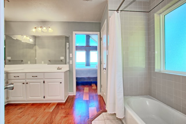 160 Somerset, Milam, TX 75959 - bathroom featuring hardwood / wood-style floors, shower / tub combo with curtain, and a wealth of natural light