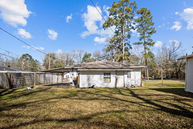 exterior space with a carport and fence