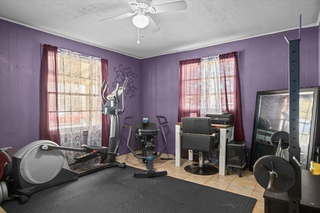 workout room with light tile patterned floors, a textured ceiling, and a ceiling fan