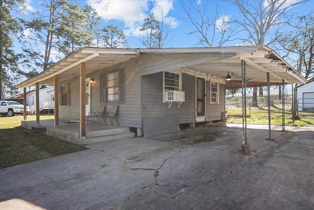 view of front of house featuring an attached carport, driveway, and covered porch