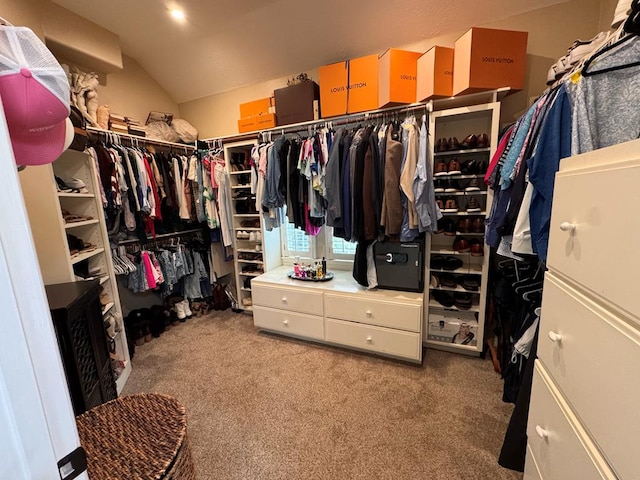 spacious closet featuring vaulted ceiling and carpet