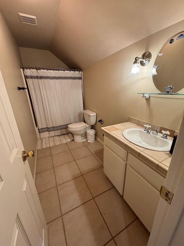 bathroom with toilet, visible vents, tile patterned flooring, vaulted ceiling, and vanity