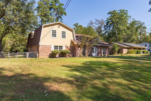 309 Hunters Creek Dr, Lufkin, TX 75901 - dutch colonial featuring a gambrel roof, brick siding, and a gate