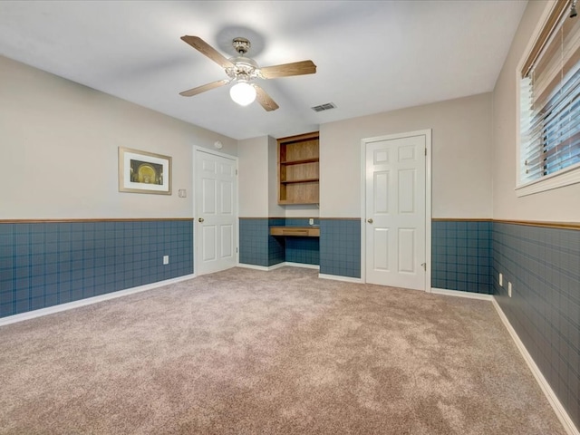 unfurnished bedroom featuring carpet and ceiling fan