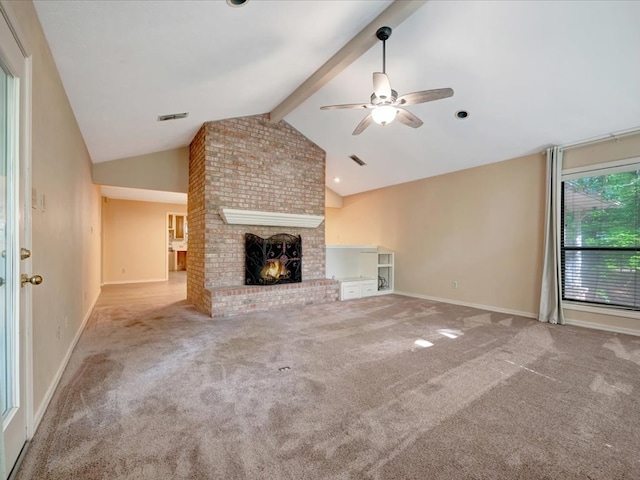 unfurnished living room with vaulted ceiling with beams, ceiling fan, light carpet, and a brick fireplace