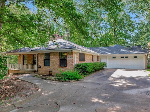 single story home with a porch and a garage