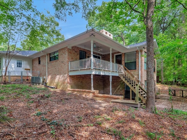 rear view of house featuring central AC and ceiling fan