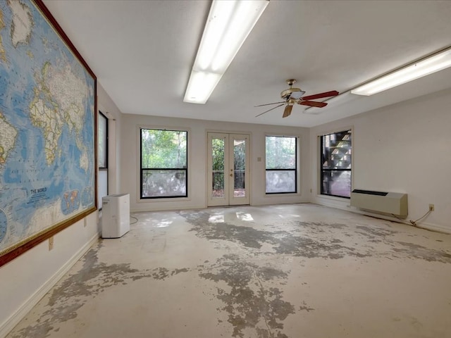 spare room with ceiling fan and french doors