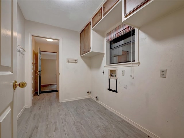 laundry area with hookup for an electric dryer, washer hookup, cabinets, gas dryer hookup, and light hardwood / wood-style flooring