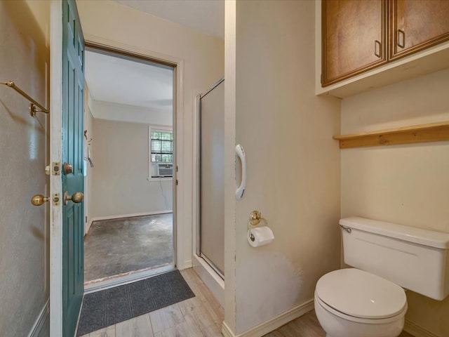 bathroom with toilet, a shower with door, cooling unit, and hardwood / wood-style flooring