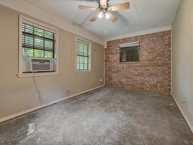 empty room featuring ceiling fan, cooling unit, and brick wall