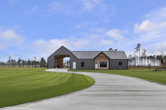 modern farmhouse style home with an outbuilding and a front lawn