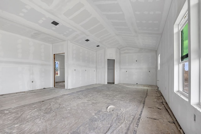 unfurnished room featuring lofted ceiling