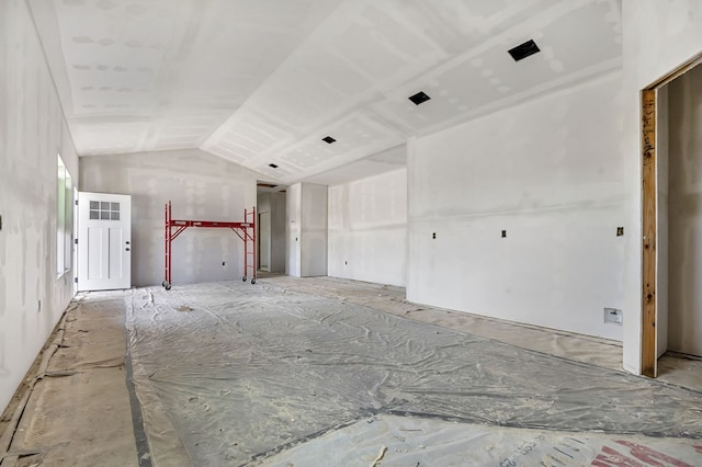 unfurnished living room with lofted ceiling