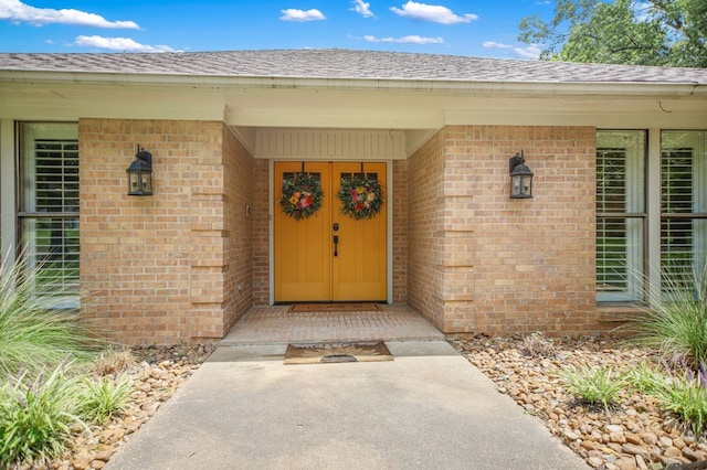 1405 Oak Hill Pl, Lufkin, TX 75904 - doorway to property featuring brick siding and a shingled roof
