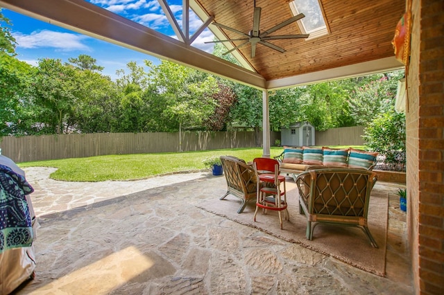 1405 Oak Hill Pl, Lufkin, TX 75904 - fenced backyard with ceiling fan, a storage unit, a patio area, and an outdoor hangout area