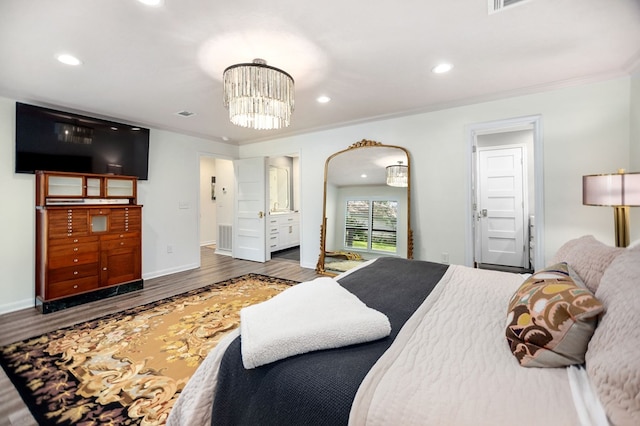 1405 Oak Hill Pl, Lufkin, TX 75904 - bedroom featuring wood finished floors, crown molding, recessed lighting, a chandelier, and arched walkways