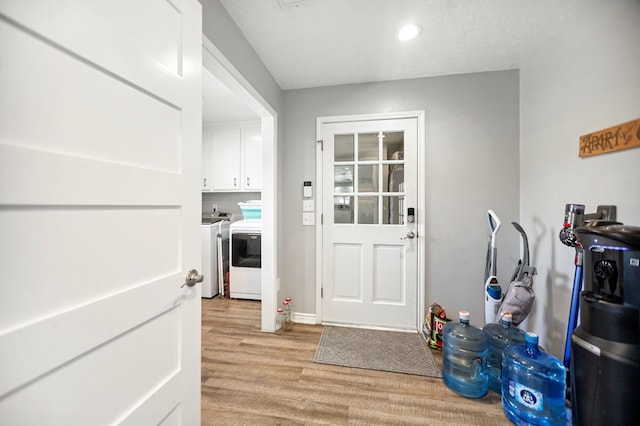1405 Oak Hill Pl, Lufkin, TX 75904 - doorway featuring washer and dryer, light wood-style flooring, and recessed lighting