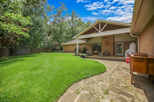 1405 Oak Hill Pl, Lufkin, TX 75904 - fenced backyard with a ceiling fan, a patio area, and a storage unit
