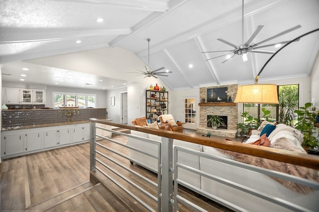 1405 Oak Hill Pl, Lufkin, TX 75904 - kitchen featuring ceiling fan, wood finished floors, a stone fireplace, recessed lighting, and white cabinets