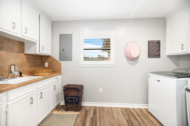 1405 Oak Hill Pl, Lufkin, TX 75904 - washroom featuring washer / dryer, electric panel, cabinet space, and light wood-type flooring