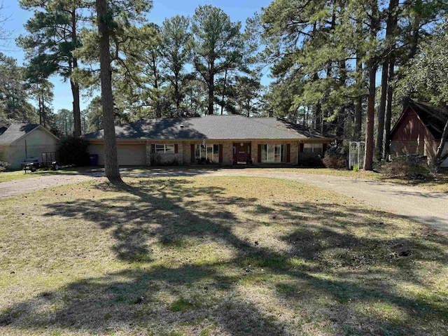 ranch-style home with a front yard and a garage