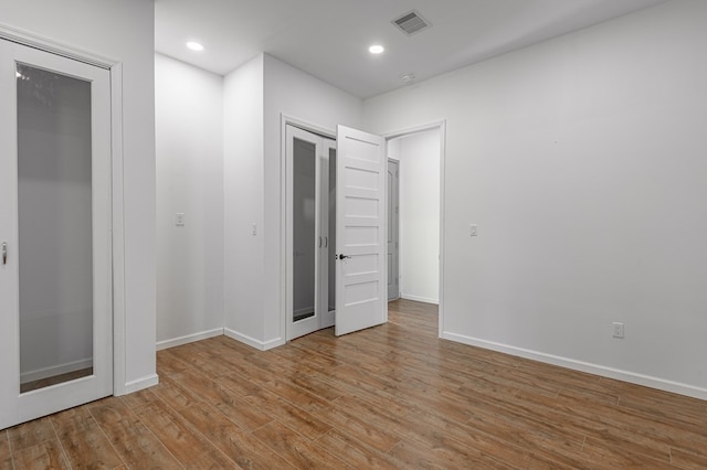 20 Coolcrest Dr, Point Blank, TX 77364 - unfurnished bedroom with wood finished floors and recessed lighting