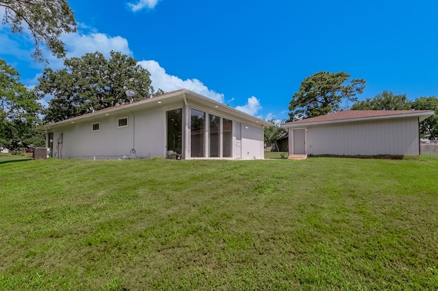20 Coolcrest Dr, Point Blank, TX 77364 - back of property featuring a lawn and a sunroom