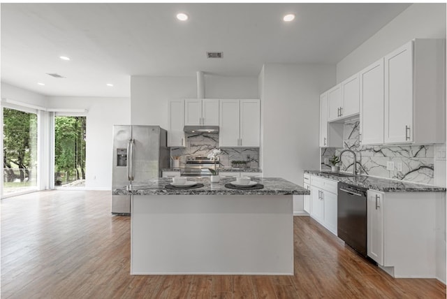 20 Coolcrest Dr, Point Blank, TX 77364 - kitchen with stainless steel fridge, black dishwasher, stone counters, a kitchen island, and recessed lighting