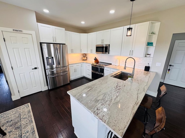 304 Lcr 485, Mexia, TX 76667 - kitchen featuring a peninsula, open shelves, light stone counters, a sink, and stainless steel appliances