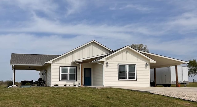 304 Lcr 485, Mexia, TX 76667 - view of front of home with board and batten siding, a carport, roof with shingles, a front lawn, and driveway