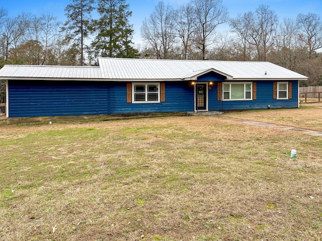 ranch-style house with a front yard and metal roof