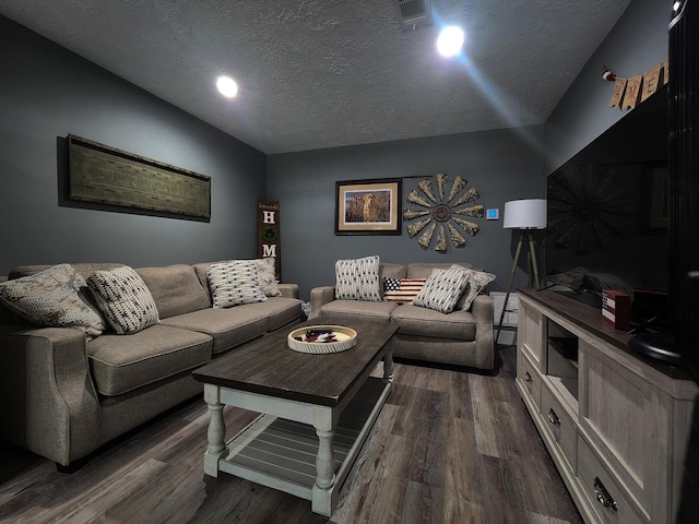 living room featuring a textured ceiling and dark hardwood / wood-style flooring