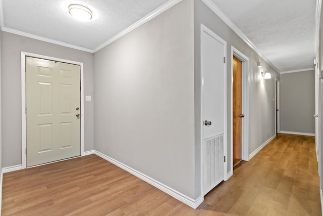 foyer entrance featuring light hardwood / wood-style floors and ornamental molding