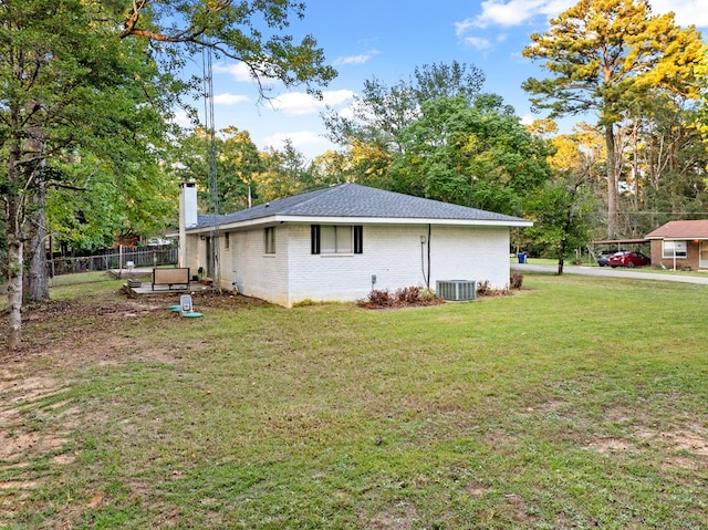 view of home's exterior featuring cooling unit and a lawn