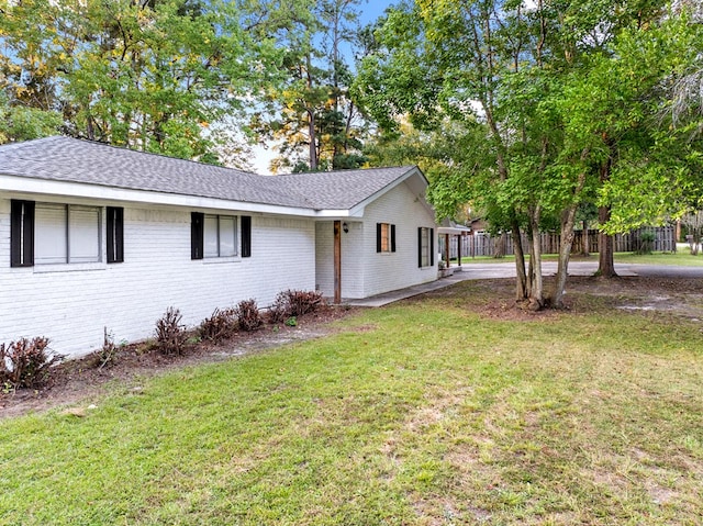 view of side of property featuring a yard