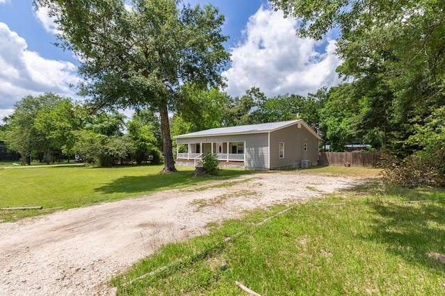 240 W 7th St, Trinity, TX 75862 - view of front of home with covered porch and metal roof