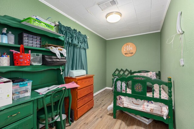 240 W 7th St, Trinity, TX 75862 - bedroom with ornamental molding, wood finished floors, and an office area