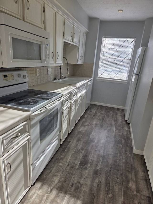 kitchen featuring a sink, white appliances, tasteful backsplash, and light countertops