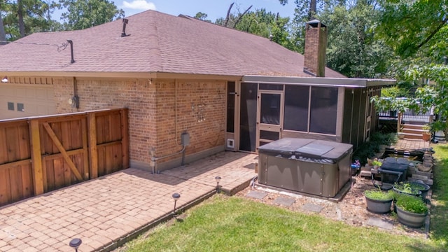 4 Pinemont Pl, Lufkin, TX 75904 - back of property with a sunroom, brick siding, a hot tub, a chimney, and a shingled roof