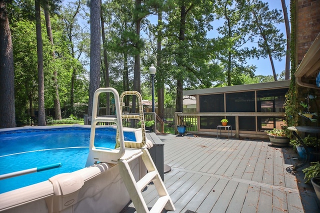 4 Pinemont Pl, Lufkin, TX 75904 - outdoor pool with a wooden deck and a sunroom