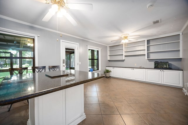 4 Pinemont Pl, Lufkin, TX 75904 - kitchen with a ceiling fan, crown molding, open shelves, white cabinets, and dark stone counters