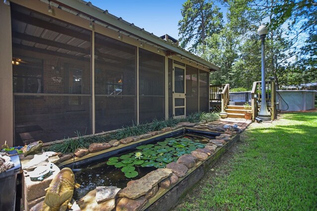 4 Pinemont Pl, Lufkin, TX 75904 - view of green lawn with a sunroom, a wooden deck, and a small pond