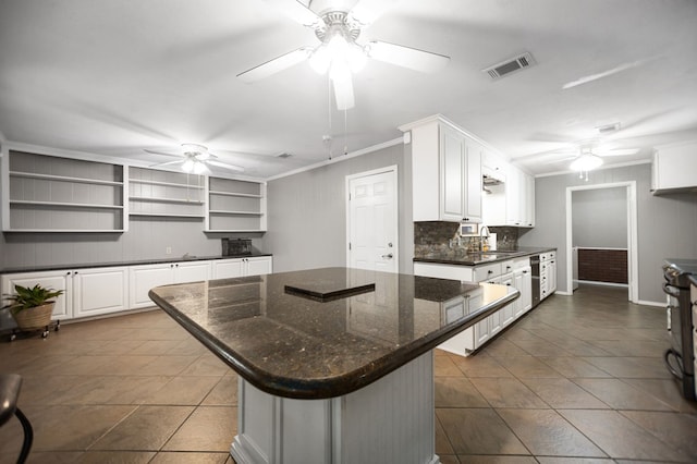 4 Pinemont Pl, Lufkin, TX 75904 - kitchen with ceiling fan, open shelves, white cabinetry, a kitchen island, and crown molding
