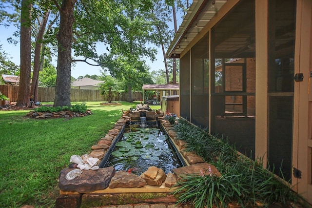 4 Pinemont Pl, Lufkin, TX 75904 - fenced backyard featuring a sunroom, a small pond, and a garden