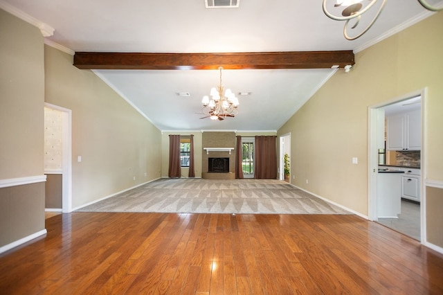 4 Pinemont Pl, Lufkin, TX 75904 - unfurnished living room with a chandelier, light wood-type flooring, a fireplace, and crown molding