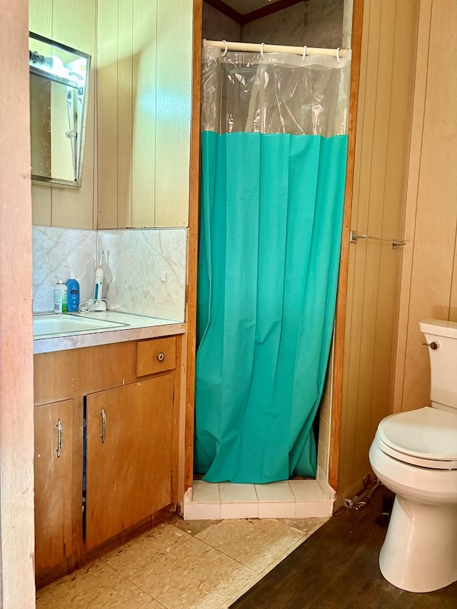 bathroom featuring hardwood / wood-style floors, vanity, toilet, and curtained shower